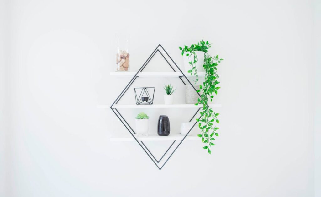 Mastering the First Impression: Your intriguing post title goes here A sleek white wall shelf with green plants and decor for a minimalist home design.